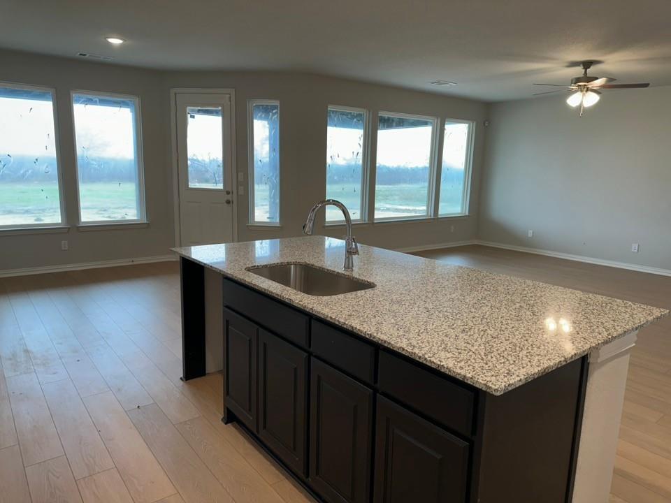 2472 Black Jack Oak Road Terrell, TX 75161 - Photo 11 of 27 a kitchen with center island wooden floor and a sink