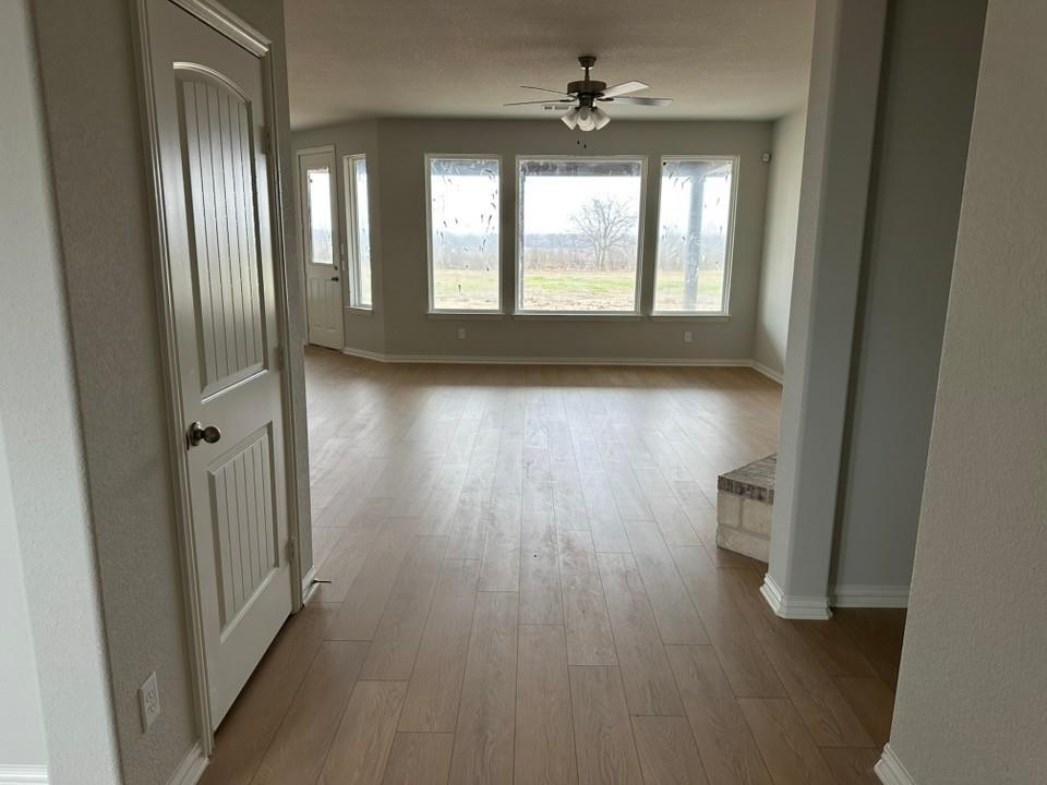 2472 Black Jack Oak Road Terrell, TX 75161 - Photo 27 of 27 an empty room with wooden floor and windows