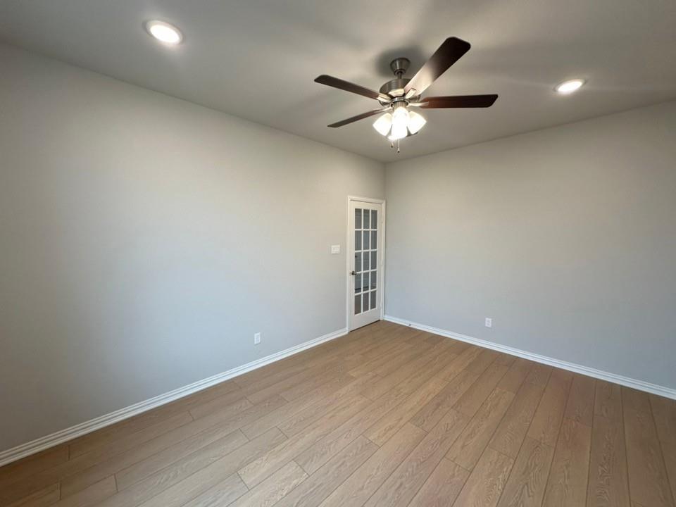 2472 Black Jack Oak Road Terrell, TX 75161 - Photo 4 of 27 a view of an empty room with wooden floor and a ceiling fan
