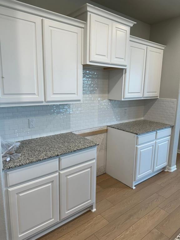 2472 Black Jack Oak Road Terrell, TX 75161 - Photo 8 of 27 a kitchen with granite countertop white cabinets and sink