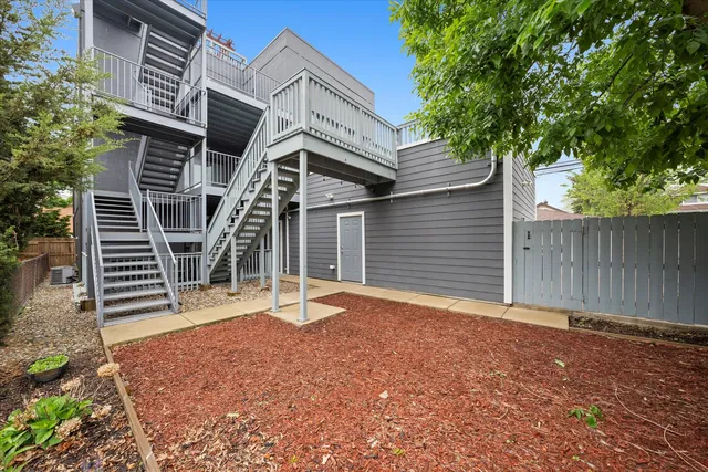 a backyard of a house with table and chairs