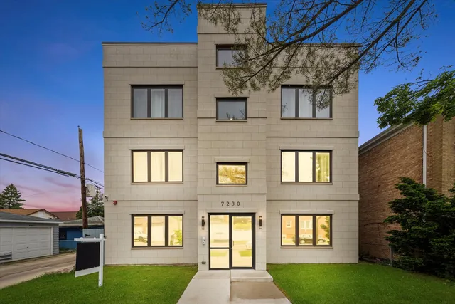 a view of a brick house with a yard