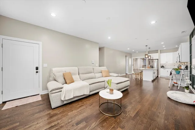 a living room with furniture and a wooden floor