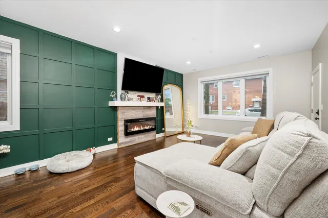 a living room with furniture a flat screen tv and a fireplace
