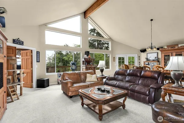 a living room with furniture a fireplace and a chandelier