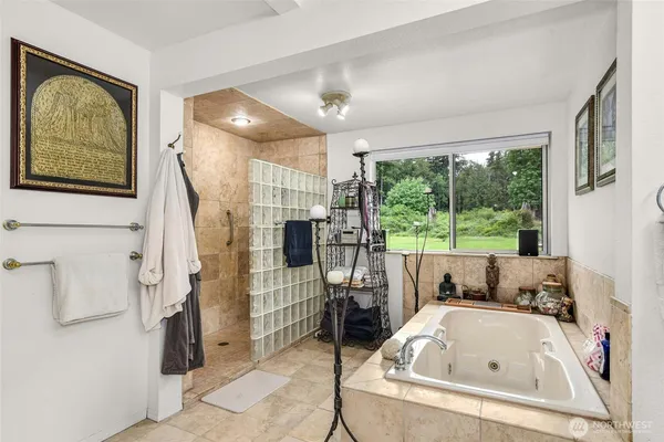 a bedroom with a bed and a dresser next to a window