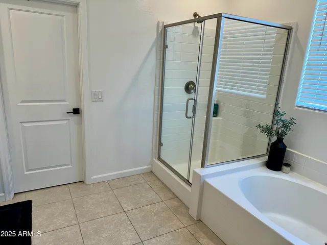 a bathroom with a tub and shower
