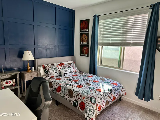 a bedroom with a bed next to a window