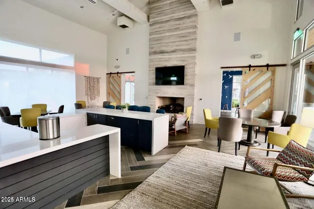 a living room with furniture kitchen view and a fireplace