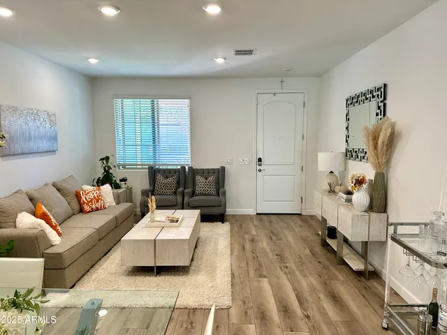 a living room with furniture and a wooden floor