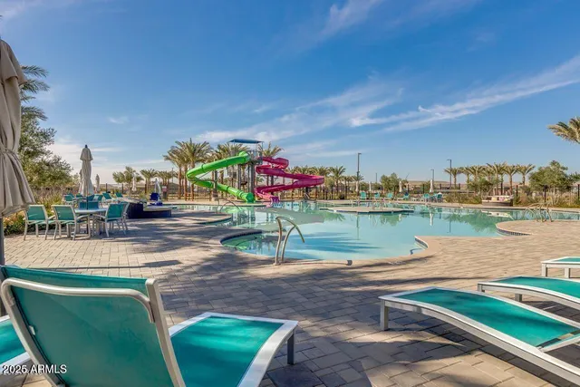 a view of swimming pool with a patio and a yard