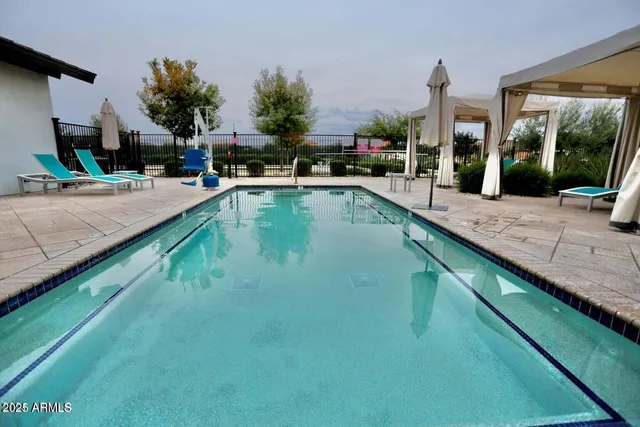 a swimming pool with outdoor seating and yard