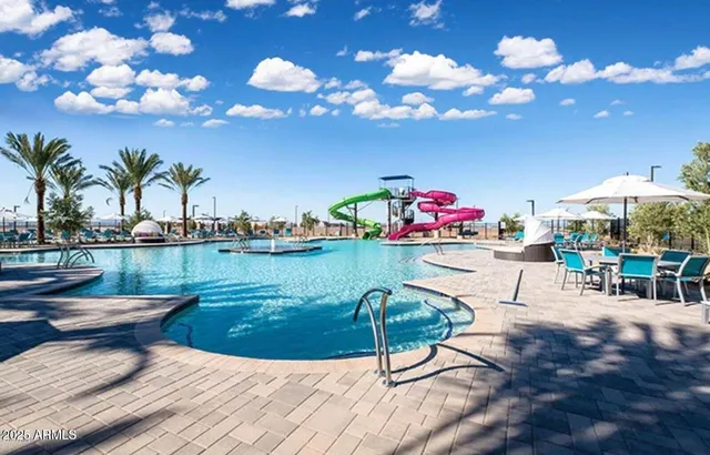 a view of swimming pool with outdoor seating
