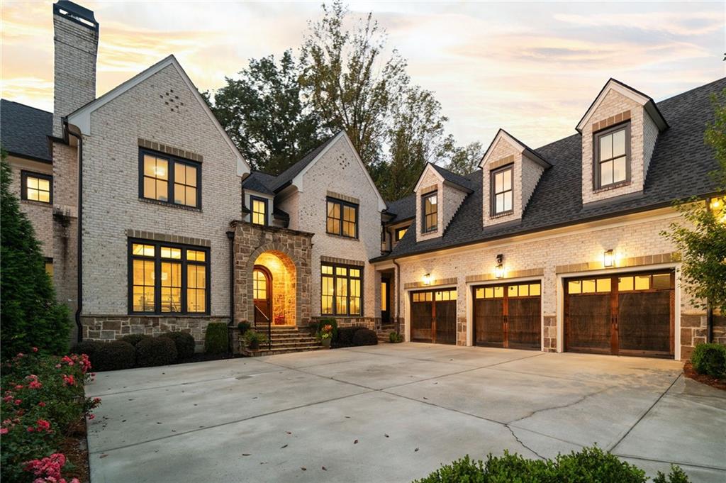 a front view of a brick house with a yard
