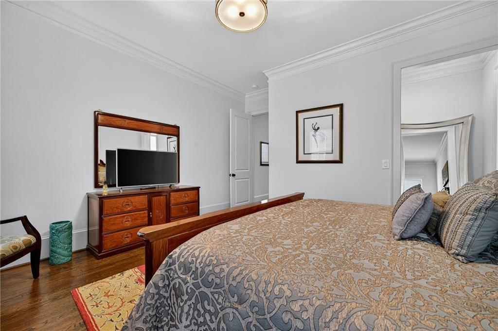 976 Ferncliff Road Northeast Atlanta, GA 30324 - Photo 19 of 58 a bedroom with a bed and a flat screen tv