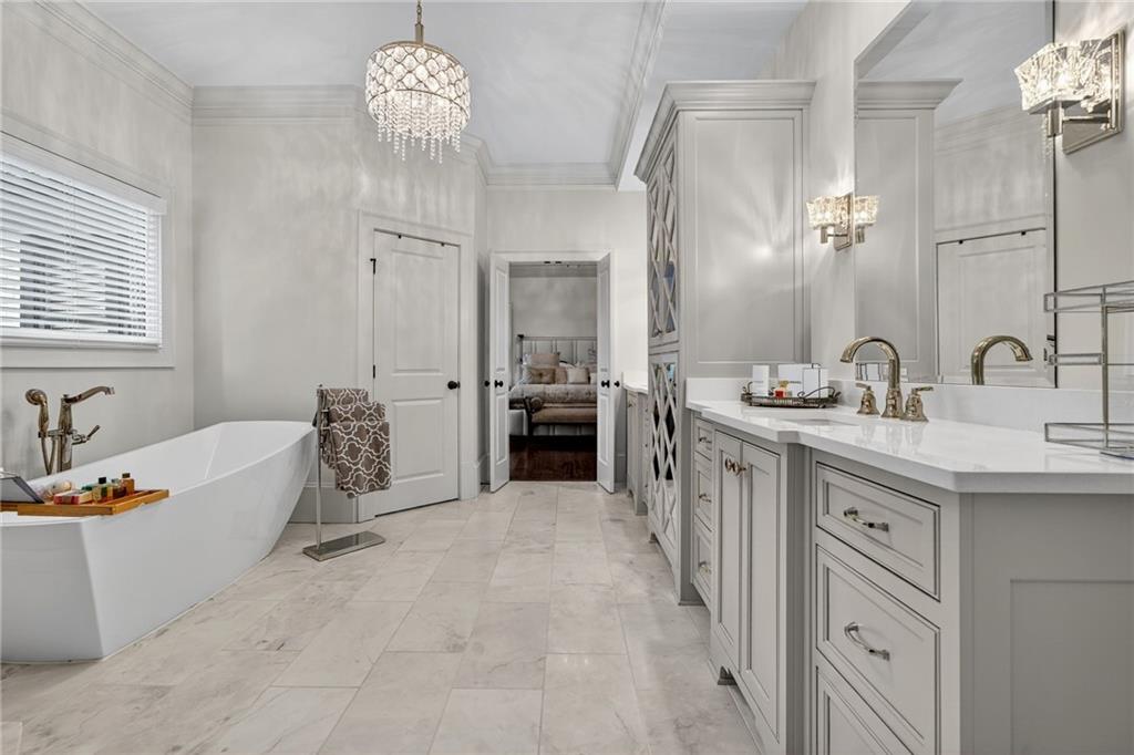 976 Ferncliff Road Northeast Atlanta, GA 30324 - Photo 26 of 58 a spacious en suite bathroom with a double vanity sink a large mirror and a bathtub