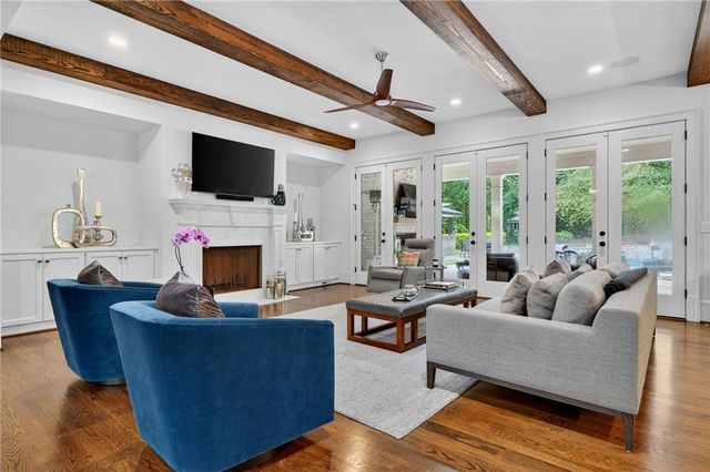 a living room with fireplace furniture and a flat screen tv