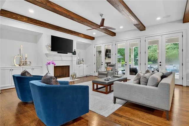 a living room with fireplace furniture and a flat screen tv