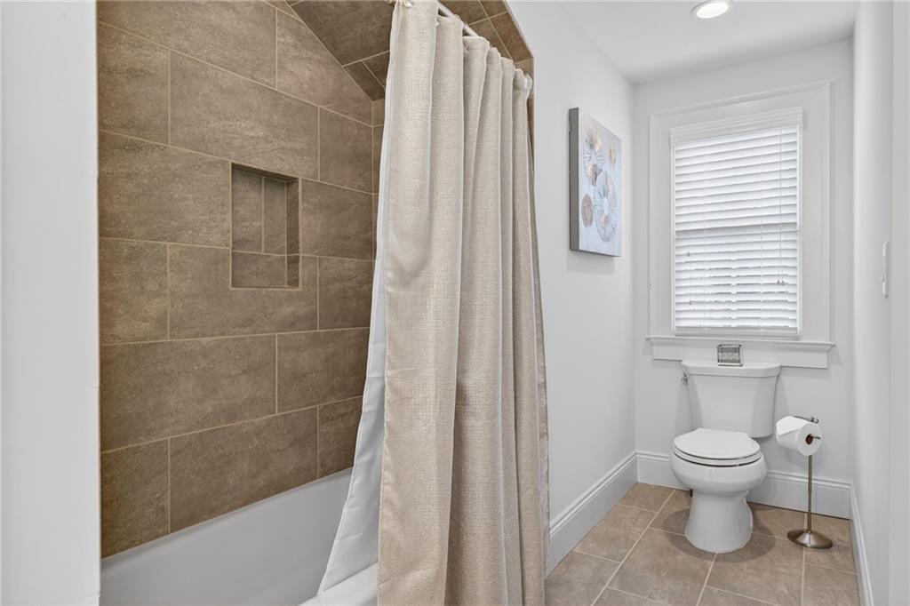 976 Ferncliff Road Northeast Atlanta, GA 30324 - Photo 33 of 58 a bathroom with a toilet and a shower