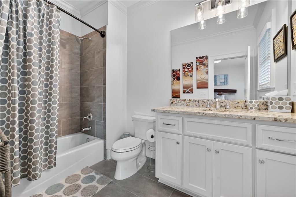 976 Ferncliff Road Northeast Atlanta, GA 30324 - Photo 35 of 58 a bathroom with a granite countertop sink toilet and shower