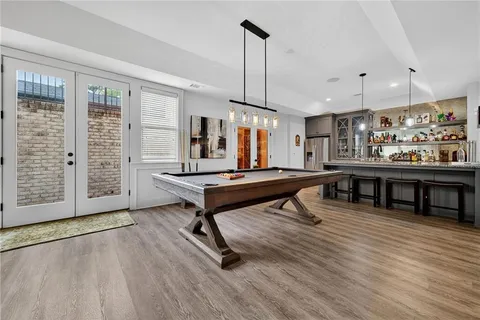 a kitchen with stainless steel appliances a sink a stove a refrigerator and cabinets