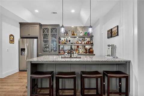 a kitchen with stainless steel appliances granite countertop a sink stove and cabinets