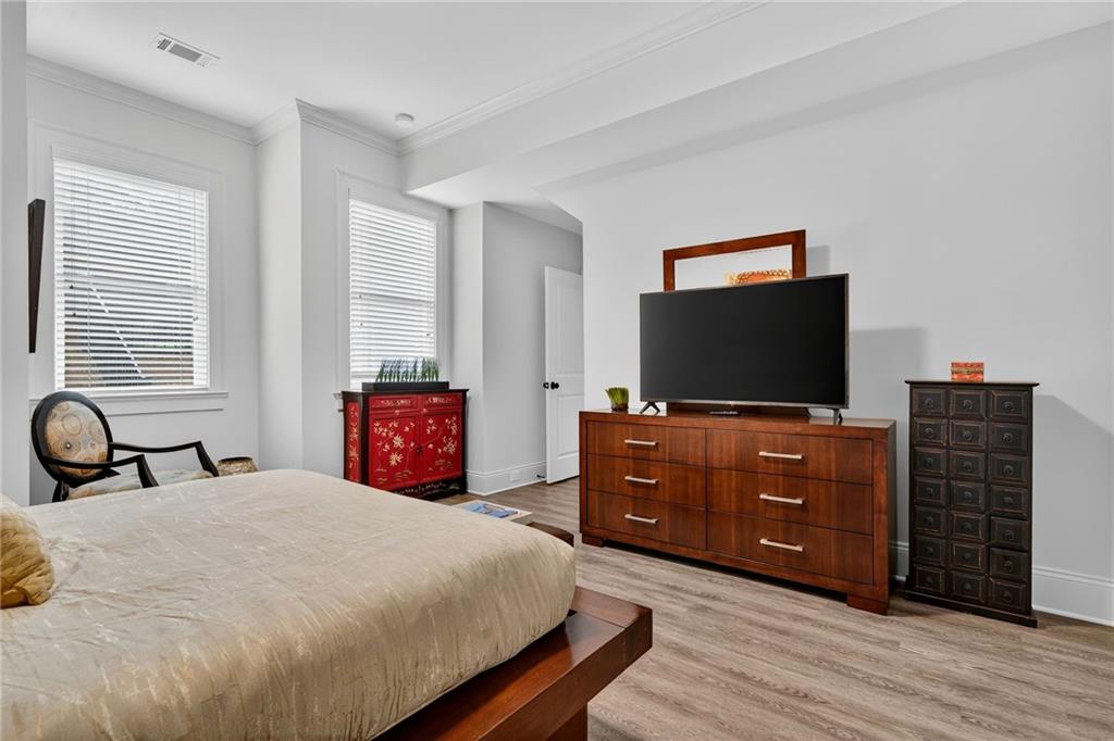 976 Ferncliff Road Northeast Atlanta, GA 30324 - Photo 48 of 58 a bedroom with a bed and flat screen tv