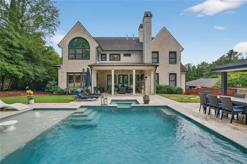a view of a swimming pool with a patio
