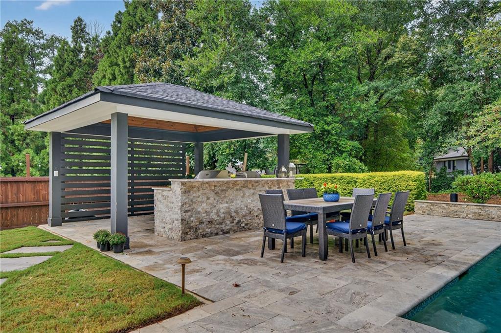 976 Ferncliff Road Northeast Atlanta, GA 30324 - Photo 54 of 58 a view of a wooden table and chairs in patio