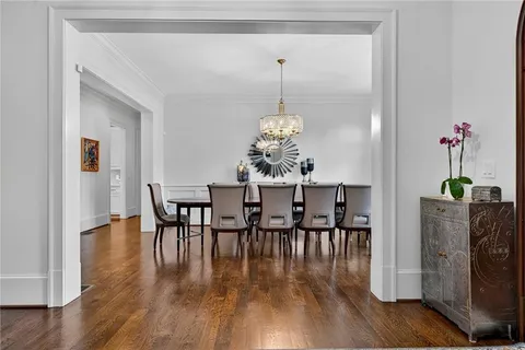 a view of a dining room with furniture wooden floor and chandelier