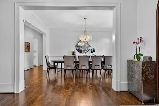 a view of a dining room with furniture wooden floor and chandelier