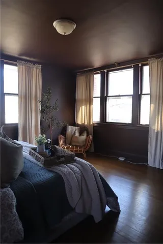 a bed sitting in a bedroom next to a window