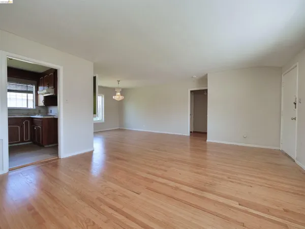 a view of a bathroom with a glass door and a wooden floor