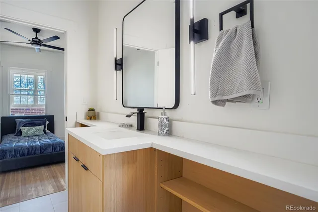 a en suite bathroom with a double vanity sink and a mirror