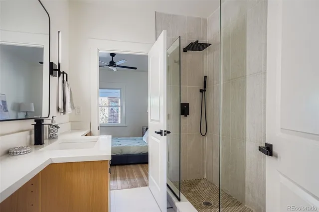 a en suite bathroom with a double vanity sink a mirror and a shower
