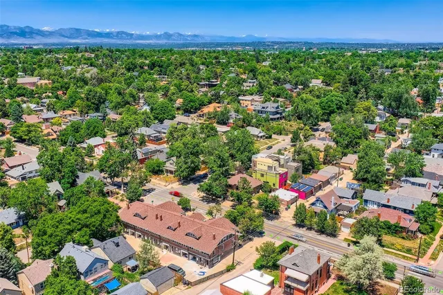 an aerial view of residential houses with outdoor space and street view