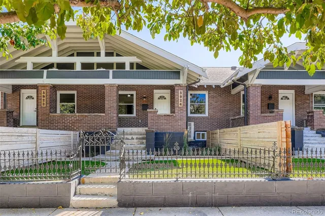a front view of a house with a garden and plants