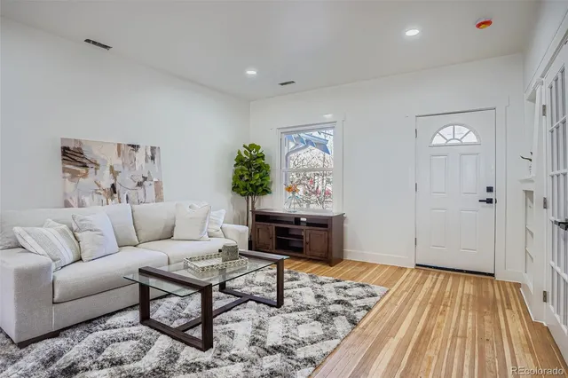 a living room with furniture and a rug