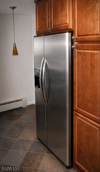 18 Springfield Avenue, Unit 4E Cranford, NJ 07016 - Photo 8 of 11 a metallic refrigerator freezer sitting in a kitchen