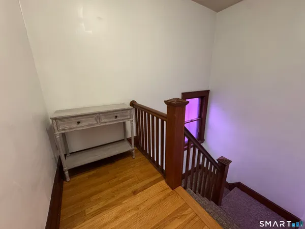 a room with stairs and a wooden floor