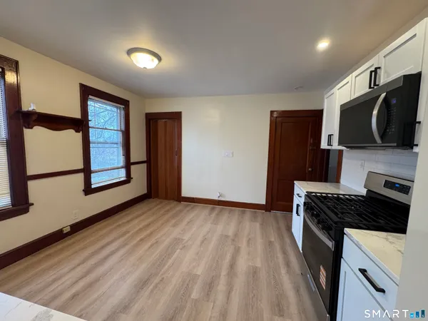 a kitchen with stainless steel appliances granite countertop a stove a refrigerator and a microwave