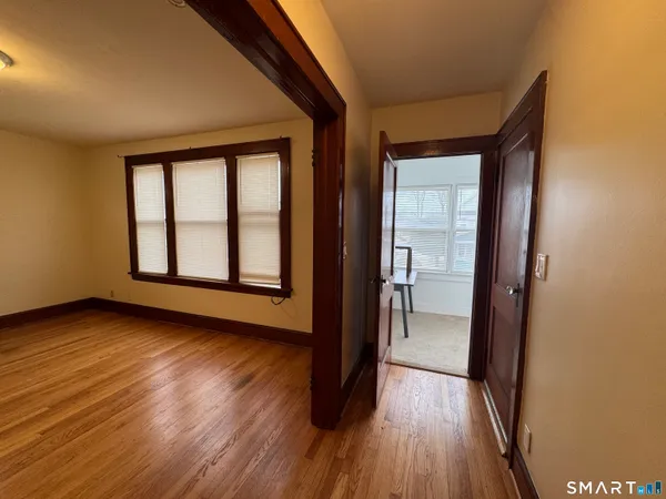 wooden floor in an empty room with a window