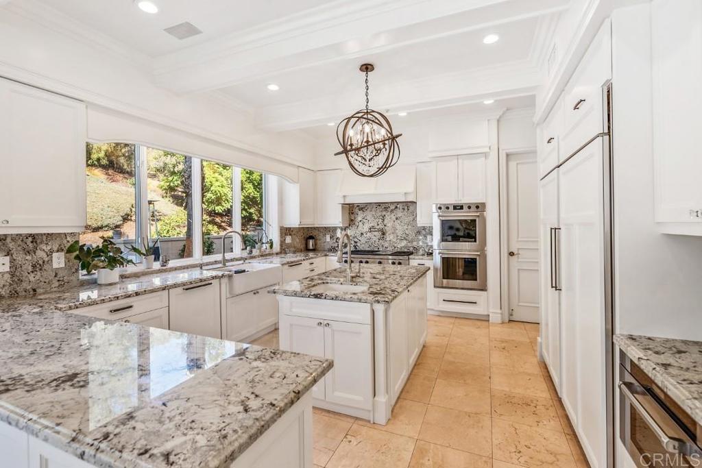 7345 Vista Rancho Court Rancho Santa Fe, CA 92091 - Photo 16 of 71 a kitchen with stainless steel appliances granite countertop a stove oven and a sink with cabinets