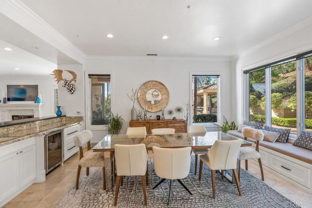 7345 Vista Rancho Court Rancho Santa Fe, CA 92091 - Photo 24 of 71 a dining room with furniture a large window and wooden floor