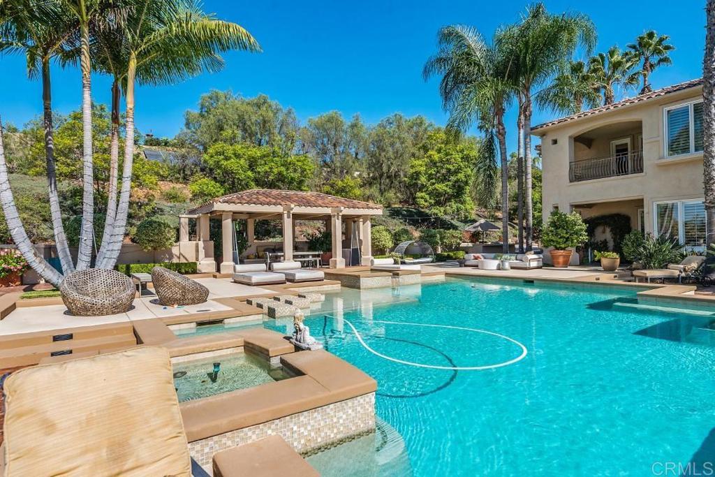 7345 Vista Rancho Court Rancho Santa Fe, CA 92091 - Photo 29 of 71 a view of a house with swimming pool and a chairs