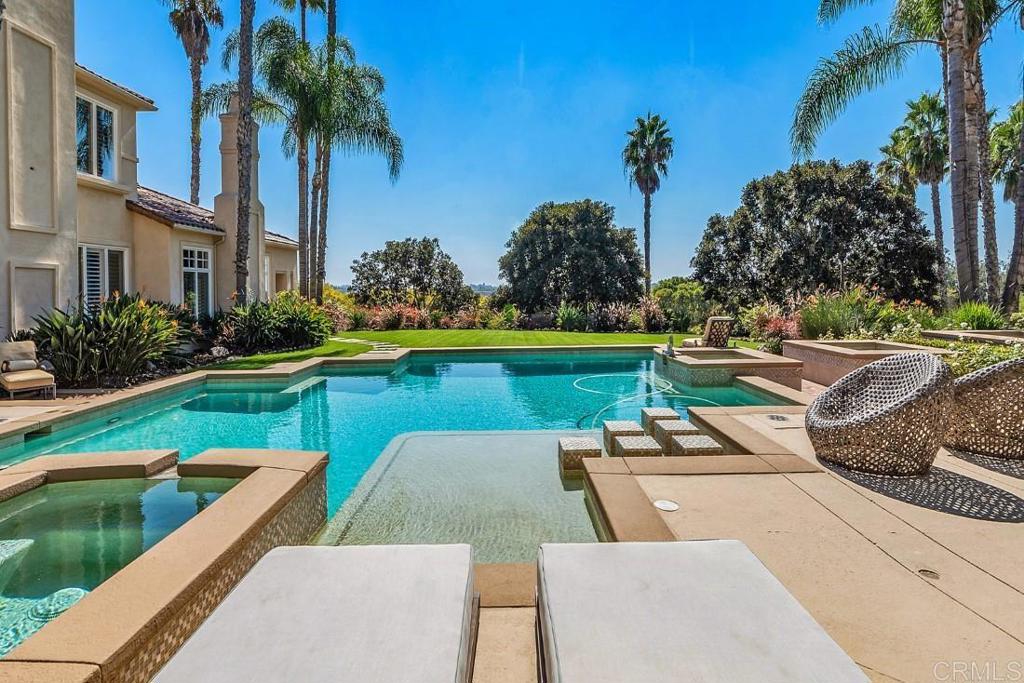 7345 Vista Rancho Court Rancho Santa Fe, CA 92091 - Photo 34 of 71 a view of a swimming pool with a garden and plants