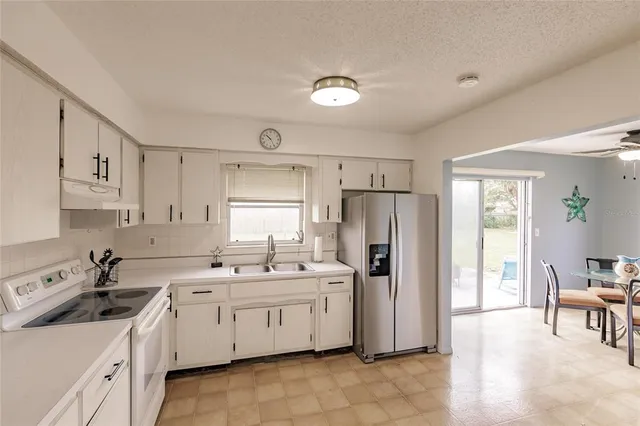 a kitchen with a sink appliances and cabinets