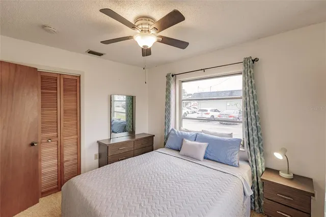 a bedroom with a large bed and a window