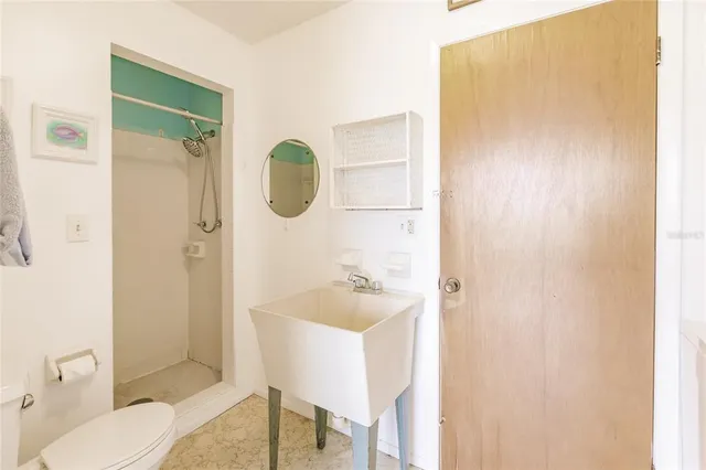 a bathroom with a sink and mirror with toilet