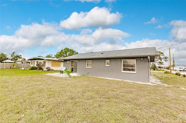 a view of a house with a yard and garage